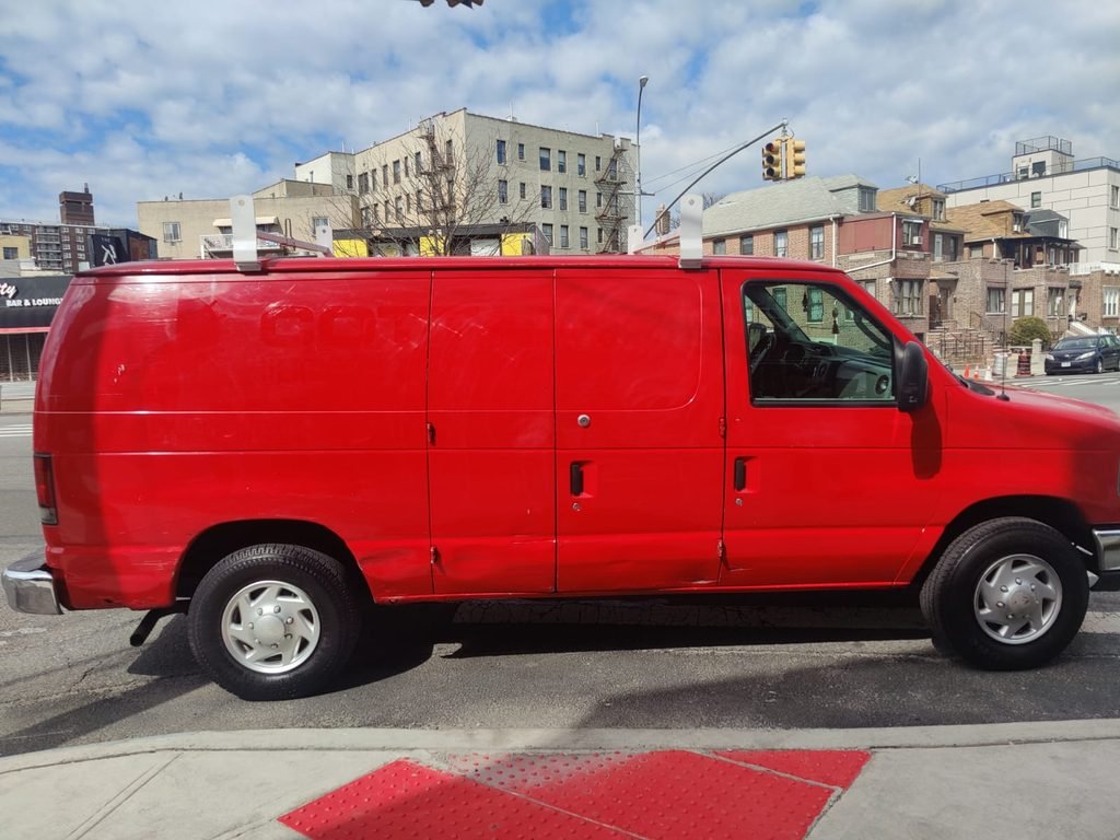 commercial red cargo van side view before vinyl lettering nyc